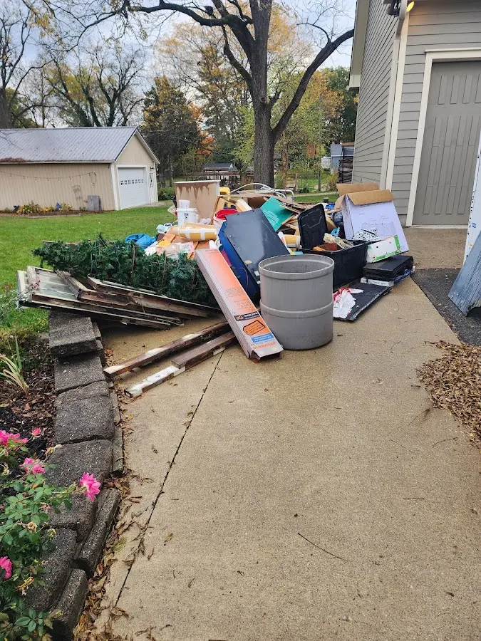 Dumpster being loaded with debris for Estate Cleanout Dumpster Rental in Kodiak